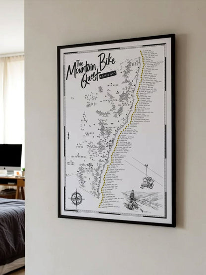 Framed NSW & ACT Mountain Bike Quest scratch map displayed on a bedroom wall