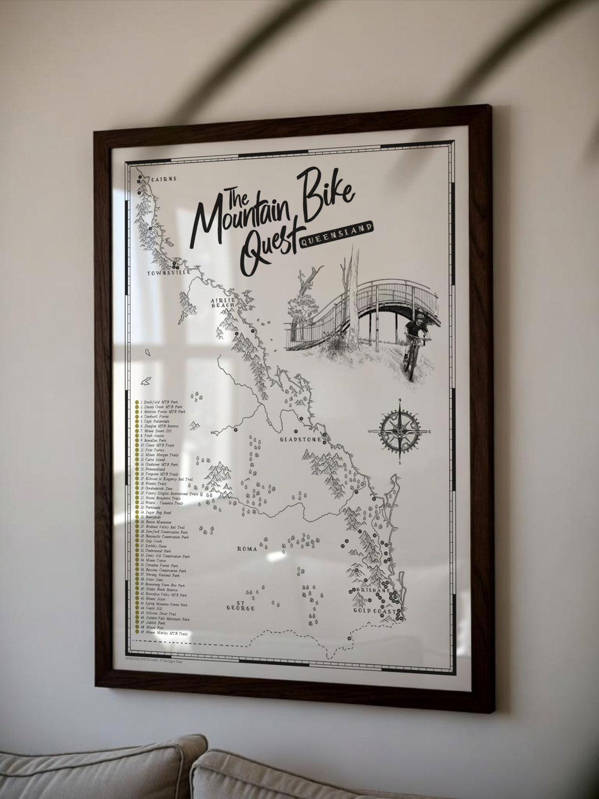 Framed Queensland Mountain Bike Quest scratch map displayed on a living room wall