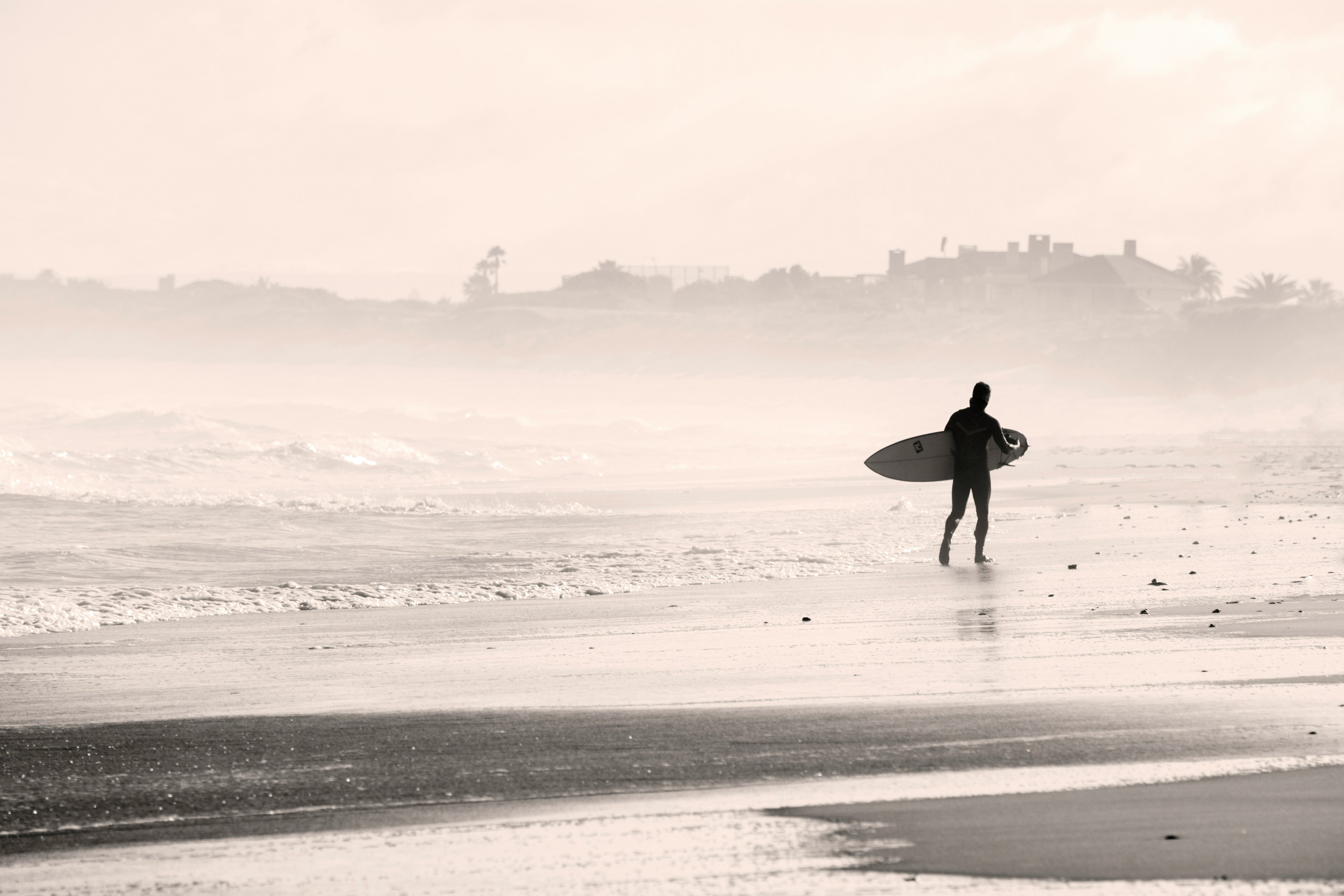 Single surfer walking down foggy beach. The Quest Maps Outdoor Scratch Maps Website