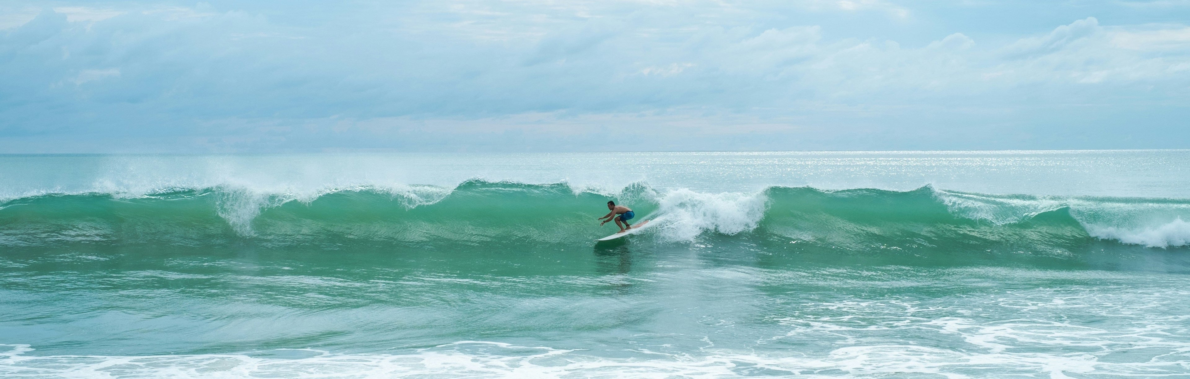 Single surfer catching a wave. The Quest Maps Outdoor Scratch Maps Website